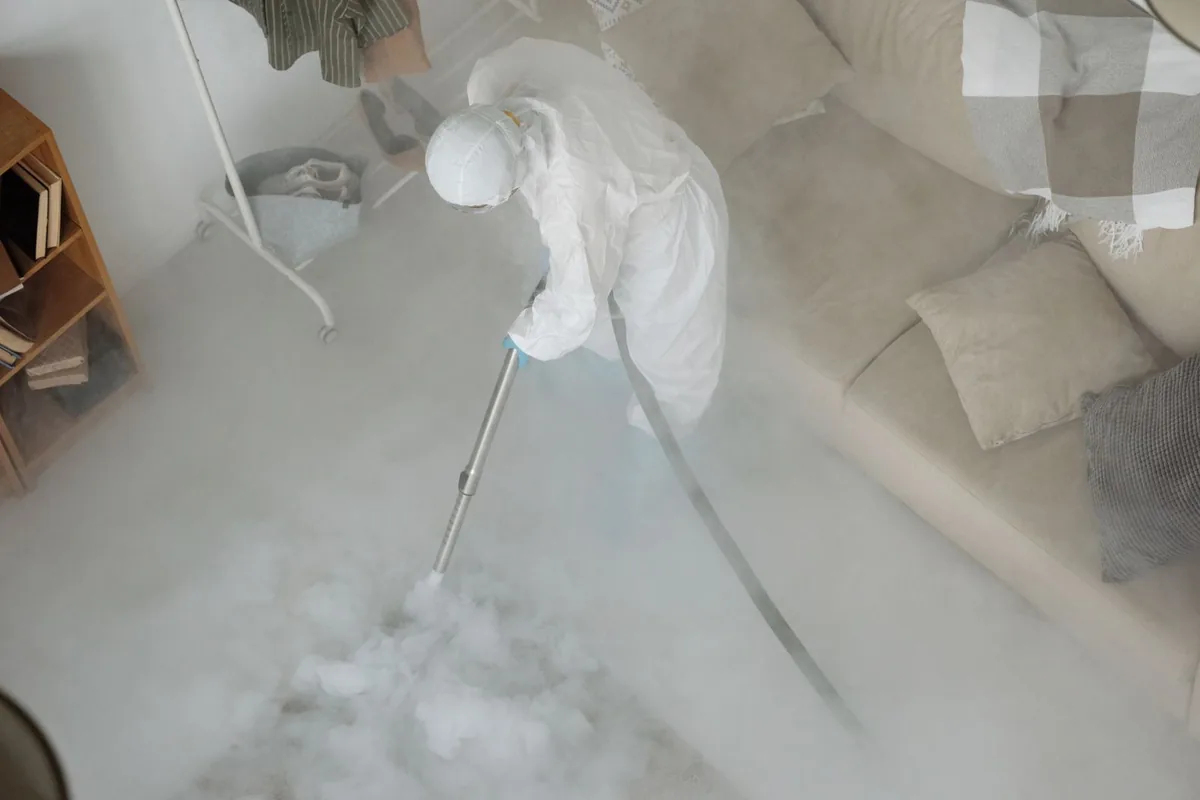 Biohazard cleanup technician in protective equipment, Alamosa, CO